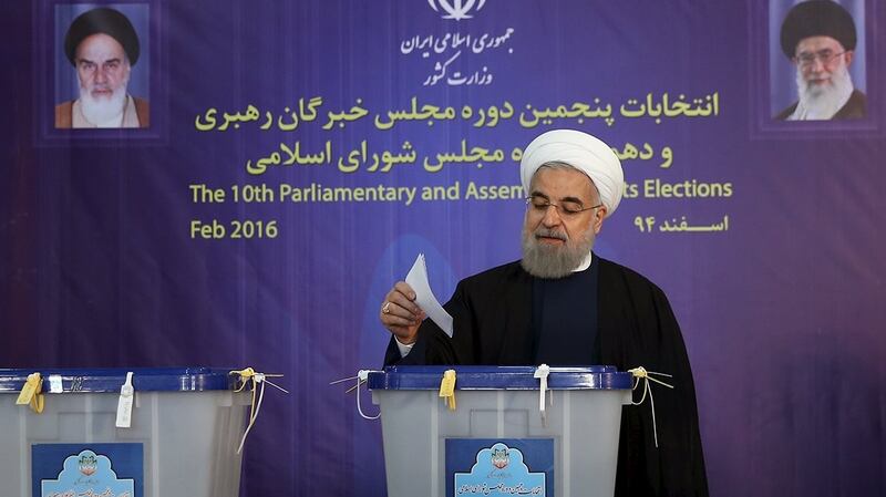Iran’s president Hassan Rouhani casts his vote during elections for the parliament and Assembly of Experts, in Tehran on Friday. Photograph: Reuters