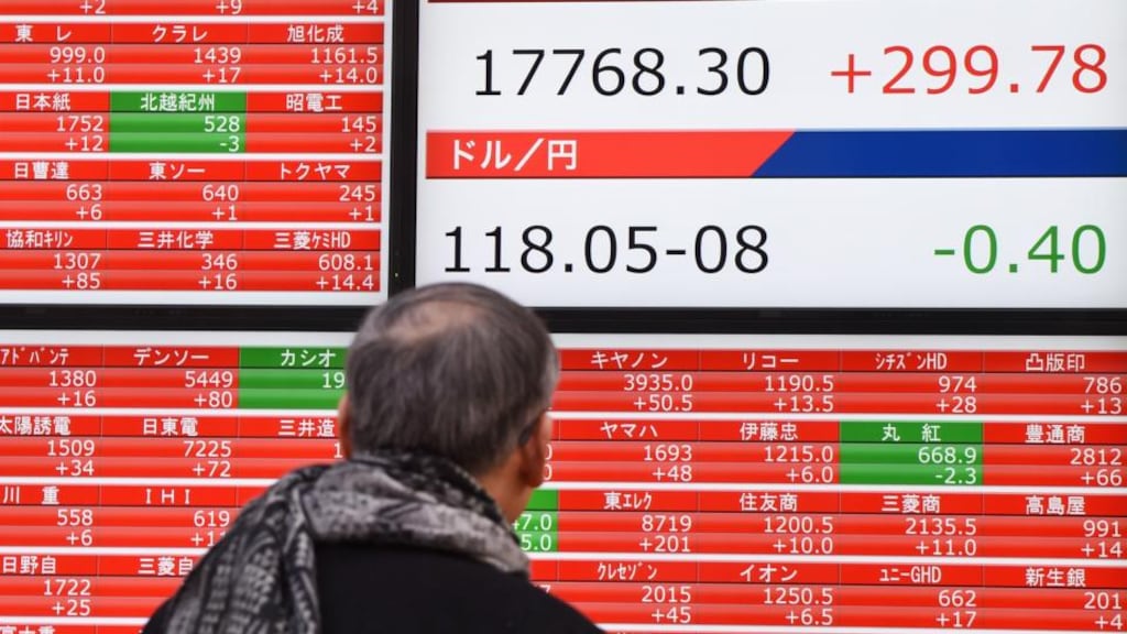 Checking Japan’s Nikkei: buying unpopular stocks on the Japanese index between 1981 and 2010 returned 13.6 per cent annually, compared with a meagre 3.97 per cent for the overall market. Photograph: Toru Yamanaka/AFP/Getty Images
