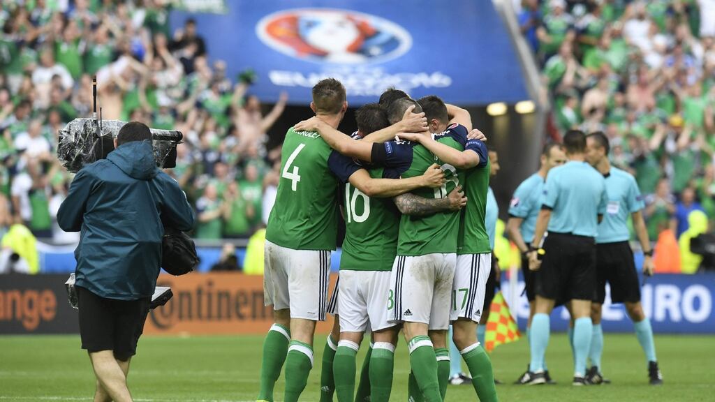 Northern Ireland team members together upon winning their Euro 2016 game against Ukraine tonight in Lyon.   A Northern Ireland fan collapsed and died during the game. Photograph: Philippe Desmazes/AFP/Getty Images