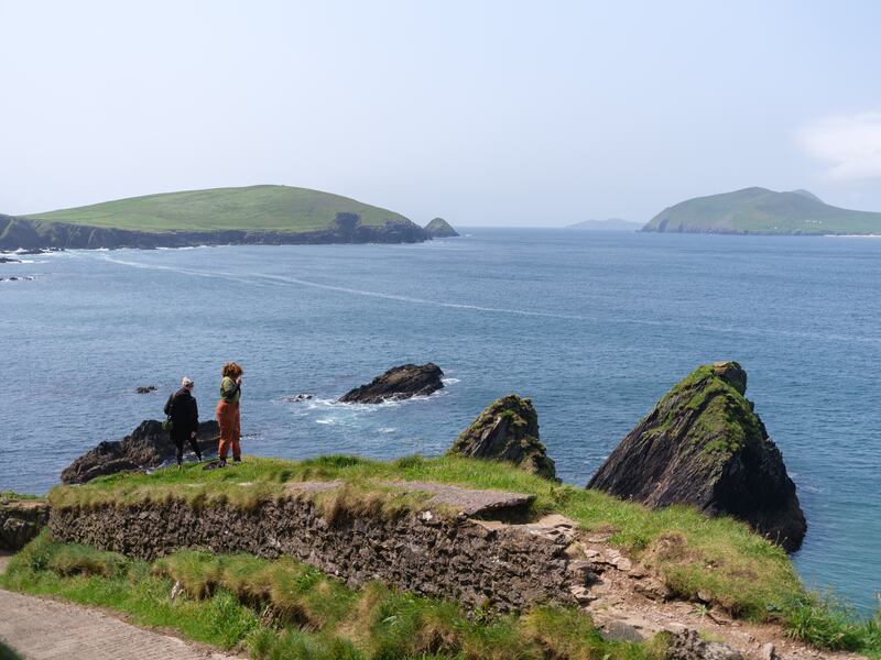 People take in the view of The Great Blasket Island from above Dunquin Harbour, Co. Kerry
