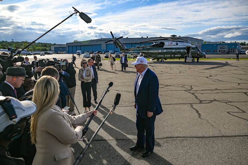President Donald Trump speaks to reporters at Morristown Municipal Airport. Photograph: Kenny Holston/The New York Times
                      