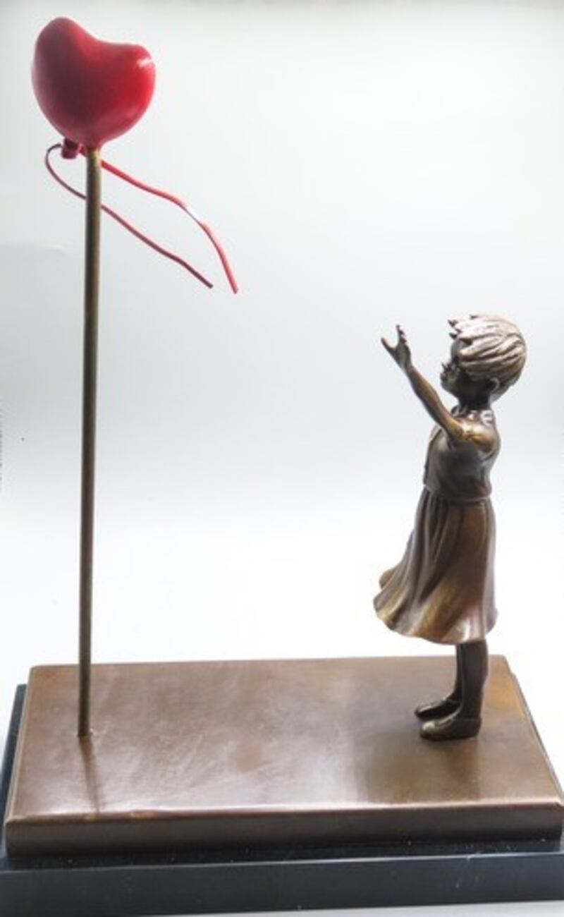 A bronze sculpture of a girl with a heart-shaped balloon (€200-€300) at Matthews auction