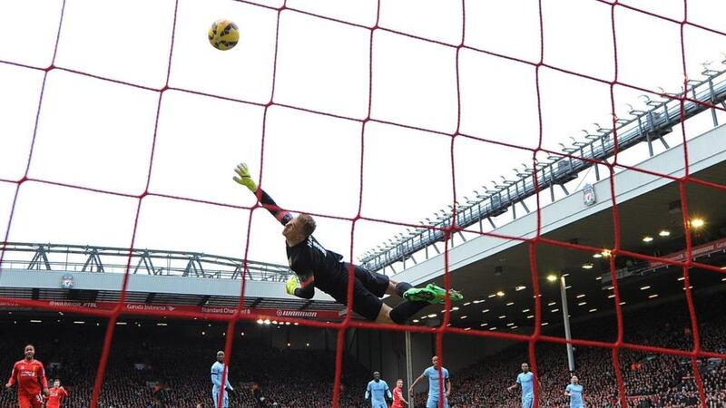 Manchester City’s Joe Hart  can’t stop Liverpool’s Jordan Henderson from scoring the opening goal. Photograph: EPA