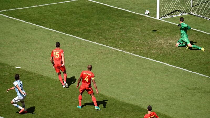 Gonzalo Higuain (left) of Argentina scores past Belgian goalkeeper Thibaut Courtois  at the Estadio Nacional in Brasilia. Photograph: Shawn Thew / EPA