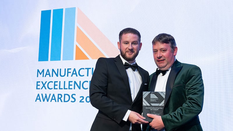 Adam Kane, community lead at Business River, presents the manufacturer of the year - life sciences award to Anthony McKeon, Lawrence Engineering