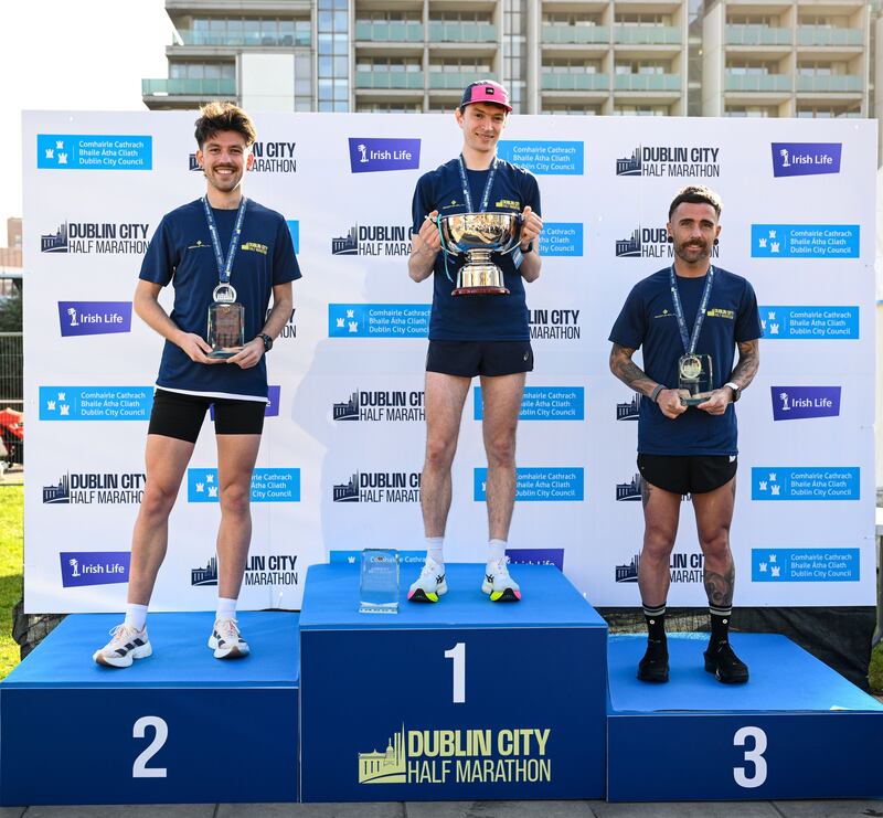 Men's race winner Killian Mooney, with second-placed Kevin Kelly, and third-placed Michael Fox, on the podium after the inaugural Dublin City Half Marathon. Photograph:  Ramsey Cardy/Sportsfile 