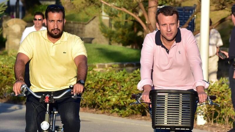 File photograph from June 17th, 2017, of French president Emmanuel Macron riding a bicycle in  northern France, accompanied by Alexandre Benalla (l).  Photograph:  Christophe Archambault/AFP/Getty Images