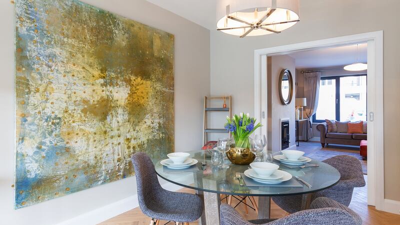 Sliding pocket doors lead through to the open plan kitchen/living/dining room to the rear.