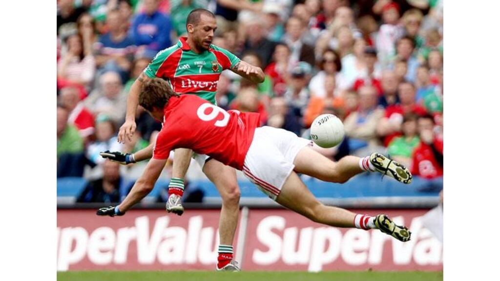 Trevor Mortimer passes the ball before Cork’s Aidan Walsh can intervene during the Mayo’s quarter-final win over the All-Ireland champions. Photograph: James Crombie/Inpho