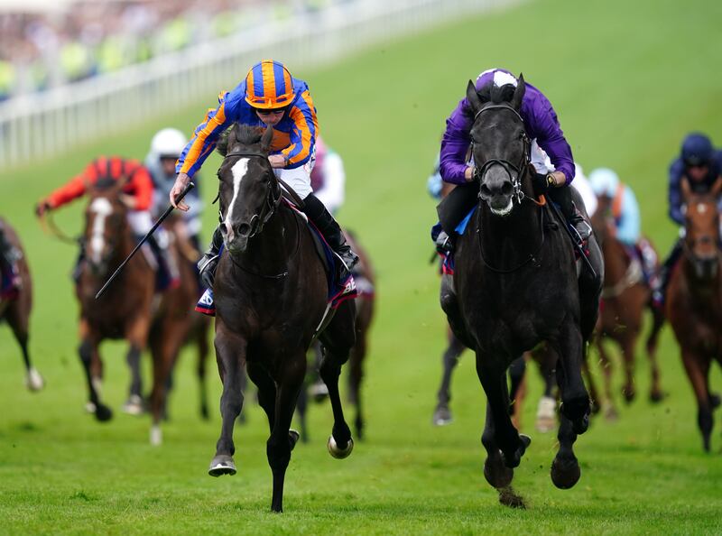 Auguste Rodin ridden by Ryan Moore (left) wins The Betfred Derby during Derby Day at Epsom Downs. Photograph: David Davies/PA Wire for The Jockey Club.
