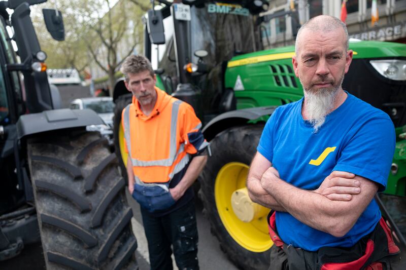 Aidan Ennis and Brian Brady with tractors and trucks blocking O’Connell Street in Dublin for a national fuel protest taking place over energy prices caused by ongoing war in the Middle East. Photograph: Chris Maddaloni