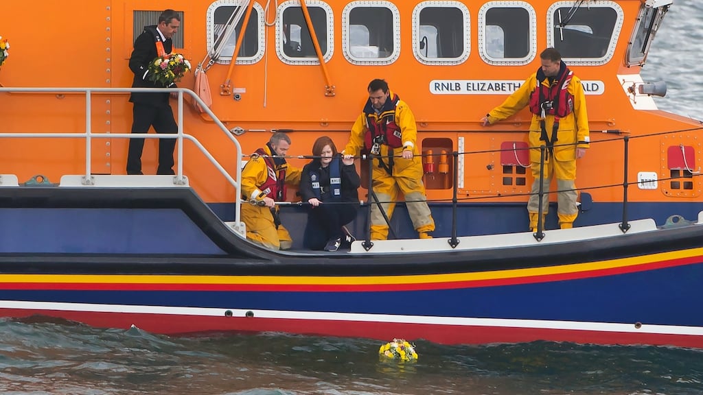 Niamh Fitzpatrick, sister of helicopter crew member Capt Dara Fitzpatrick, lays a wreath from an RNLI lifeboat at Dunmore East, Co Waterford, on Easter Sunday. Photograph: Patrick Browne