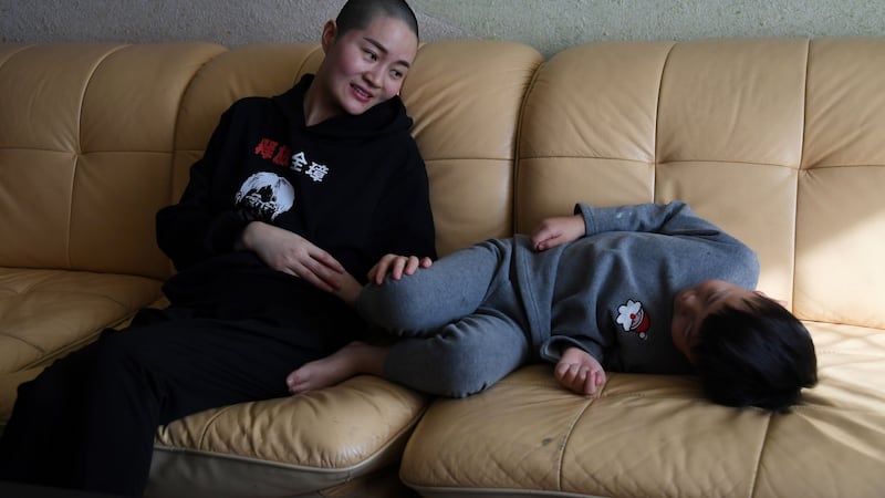 Li Wenzu, the wife of imprisoned lawyer Wang Quanzhang, talks with their son Wang Guangwei at their home in Beijing on Monday. Photograph: Greg Baker/AFP/Getty Images