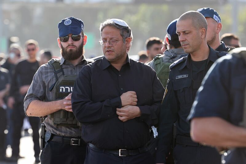 Israeli national security minister Itamar Ben Gvir is escorted by security officials as he visits the area of a shooting attack at an entrance to  Jerusalem. Three people, including a pregnant woman, were killed in the attack. The two Palestinians who carried out the attack were killed by police. Photograph: Abir Sultan/EPA