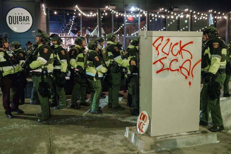 Dozens of armed Minnesota police officers are seen next to anti-Ice graffiti during a protest outside of one of the hotels where Immigration and Customs Enforcement agents are thought to be staying in Minneapolis, Minnesota. Photograph: EPA