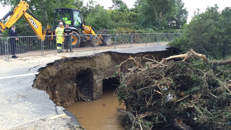Emergency crews work on a damaged bridge on the main   Derry to Moville road in Co Donegal caused by the force of a flooded river. Photograph: PA