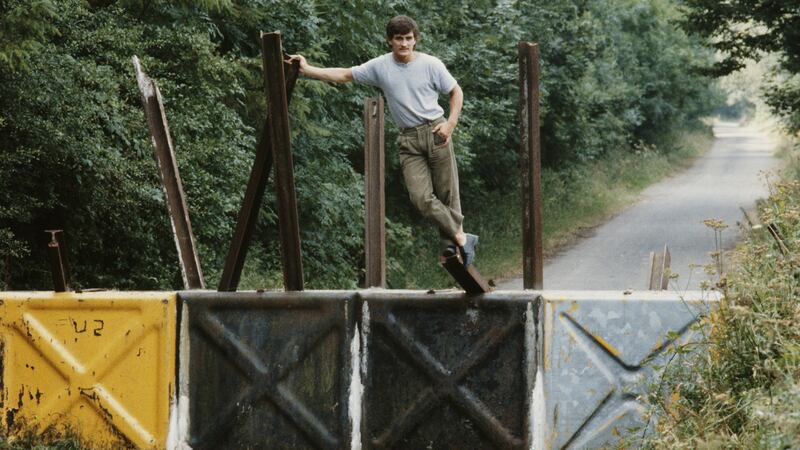 Boxer Barry McGuigan in his hometown of Clones, Co Monaghan, in 1984, posing astride the Border. Photograph: Michael Brennan/Getty Images