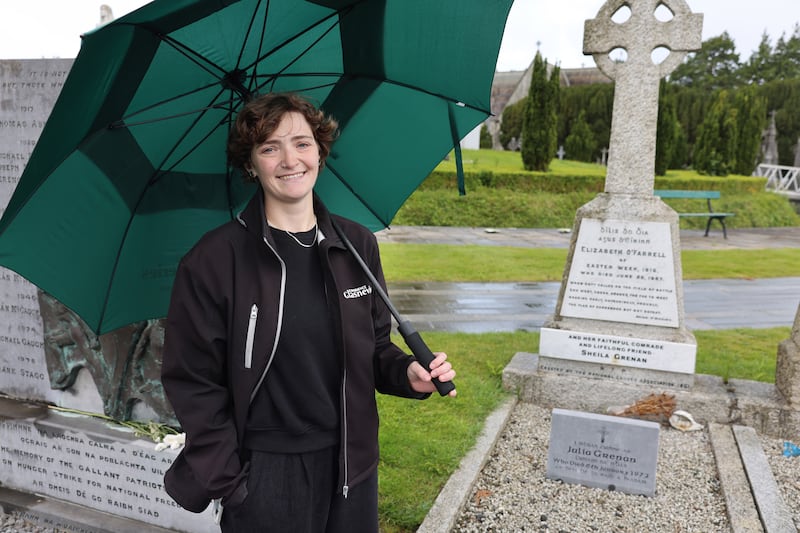 Anna Collins, tour guide at Dublin Cemeteries Trust, stands in Glasnevin Cemetery's republican plot beside the grave of Elizabeth O’Farrell and Julia Grenan, who feature in the Queer History Tour. Photograph: Dara Mac Dónaill