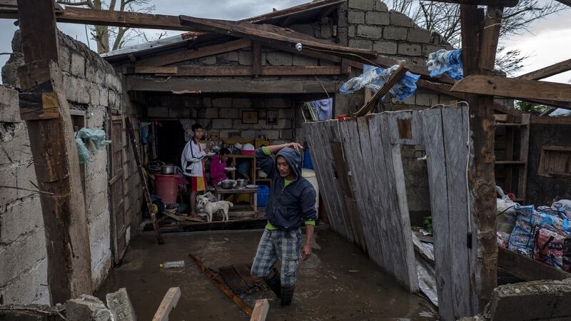 The Librador family inside their house, heavily damaged by typhoon Mangkhut, in Alcala, Philippines. Photograph: Jes Aznar/Getty Images