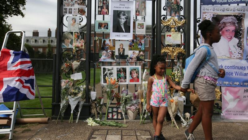 Visitors look at photographs of Diana, Princess of Wales, and floral tributes left outside Kensington Palace in Central London on August 29th, 2017 ahead of the 20th anniversary of Princess Diana’s death. Photograph: Daniel Olivasdan/Getty/AFP