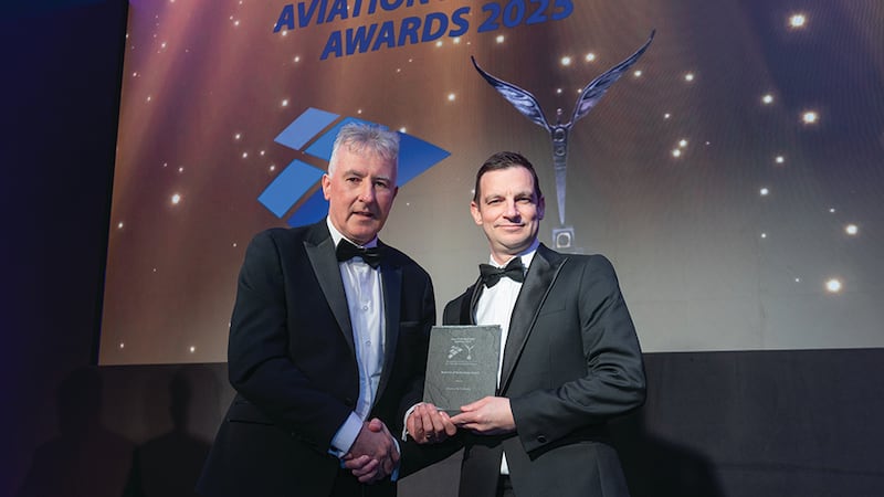 Michael Treacy, awards judge, presents the best use of technology award to Alan Hicks, Manna Air Delivery