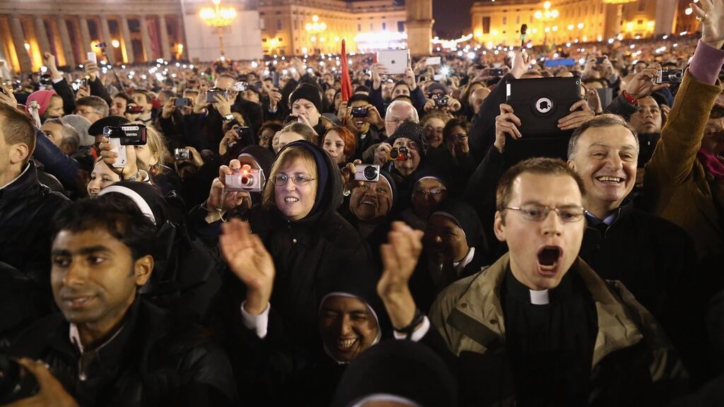 People react as newly elected Pope Francis I appears on the central balcony of St Peter's Basilica  in the Vatican tonight. Photograph: Dan Kitwood/Getty Images.