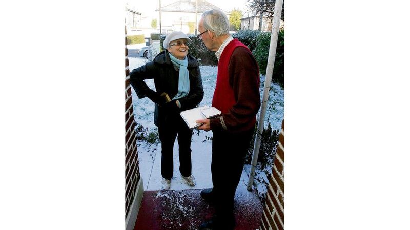 Moira McDonagh, from Donnybrook Meals on Wheels, with a customer Michael Gallagher on Bird Avenue yesterday as Dublin city was again hit with freezing conditions. Photograph: Cyril Byrne
