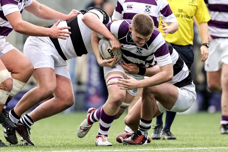 Clongowes Wood College's Matthew Ruddy is tackled by Eoin McDermott of Belvedere College. Photograph: Laszlo Geczo/Inpho