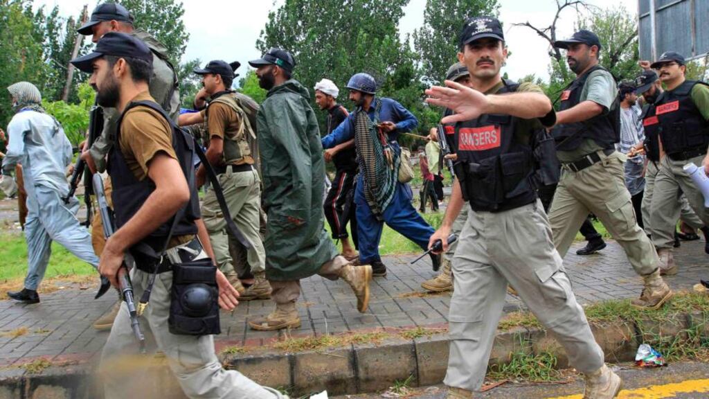 A soldier from the Pakistan Rangers gestures to stop members of the media while walking with supporters of Tahir ul-Qadri, Sufi cleric and leader of political party Pakistan Awami Tehreek (PAT), during Revolution March towards the prime minister’s house in Islamabad today. Photograph: Faisal Mahmood/Reuters