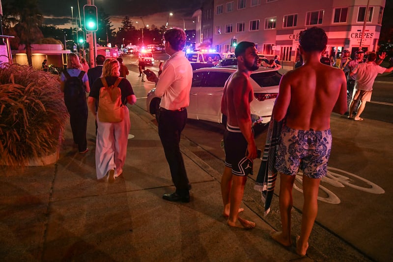 People stand on a street after a shooting incident at Bondi Beach. Photograph: Saeed Khan/AFP/Getty Images
