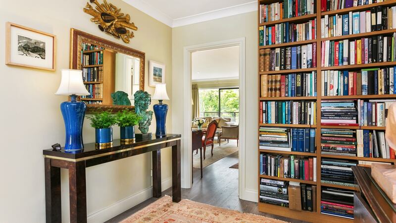 Good-sized front hall with  fitted bookshelves