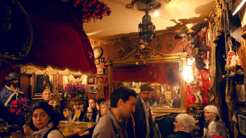 El Garlochi, a velvet-draped haunt, is done up entirely in lavish church kitsch – brass candelabras, Madonna shrines, plastic funeral bouquets, oil portraits of weeping saints. Photograph:  James Rajotte/The New York Times