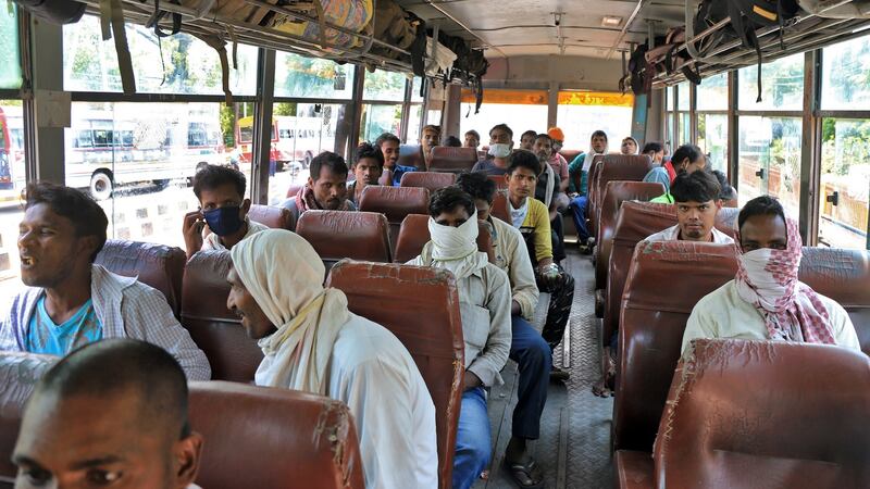 Migrant workers, who were stranded in the central state of Madhya Pradesh due to the lockdown imposed by the government to prevent the spread of coronavirus, sit in a bus as they wait to leave for their home town. Photograph:  Reuters/Jitendra Prakash