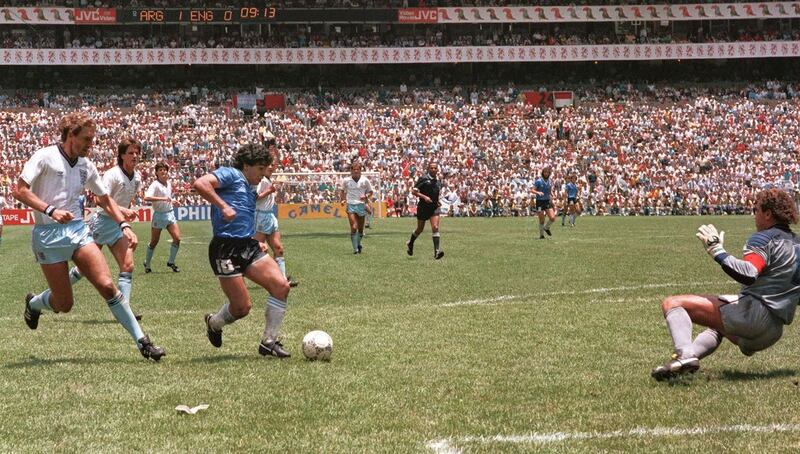 Diego Maradona runs past English defender Terry Butcher and scores his second goal against goalkeeper Peter Shilton and England in 1986. Photograph: AFP/Getty Images