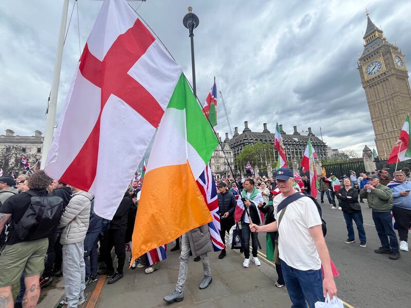 Bob Ryan, from London, flies the English and Irish flags at the Tommy Robinson March. Photograph: Mark Paul