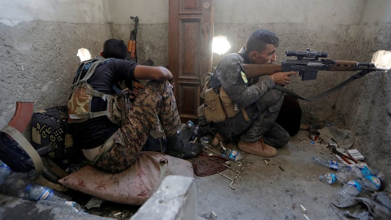 A sniper of the Syrian Democratic Forces aims his weapon during the fighting with Islamic State’s fighters in the old city of Raqqa on  August 19th. Photograph: Zohra Bensemra/Reuters