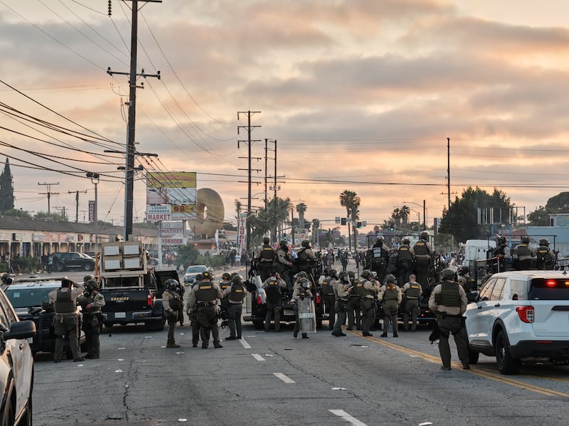  Los Angeles County sheriff’s deputies clash with protesters in Compton on Saturday. Photograph: Philip Cheung/The New York Times
                      