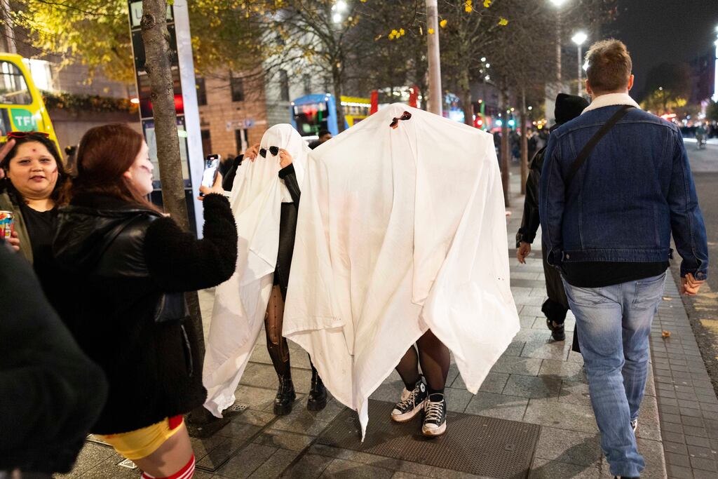 People dressed as ghosts in Dublin City Centre attend a Halloween parade which turned out to be fake. Photo: Sam Boal/Collins Photos