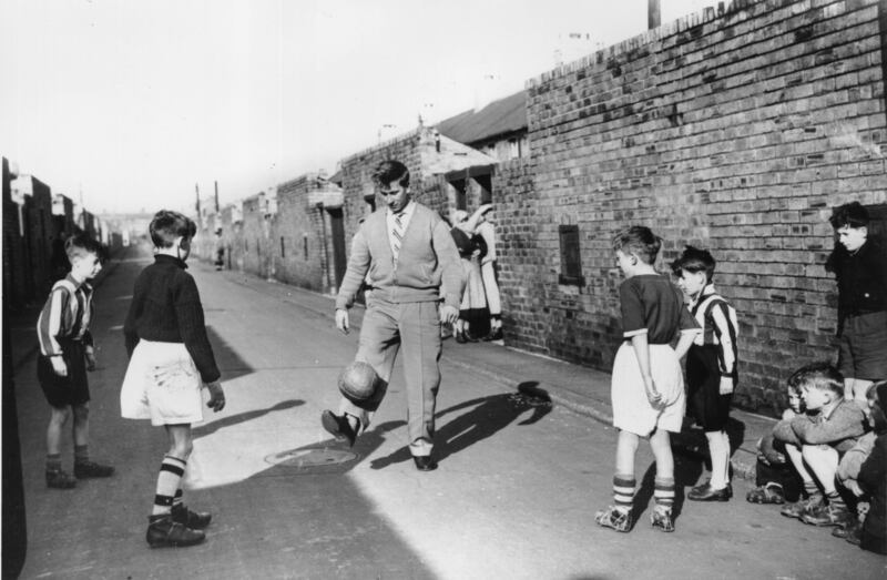 Bobby Charlton gets back into gentle training after the disaster with some young fans in the backyard of his home in Ashington on February 19th, 1958. Photograph: Keystone/Getty