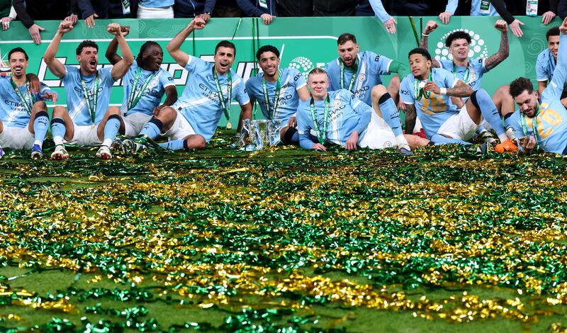 Manchester City players celebrate with the Carabao Cup trophy at Wembley Stadium on Sunday. Photograph: Julian Finney/Getty Images