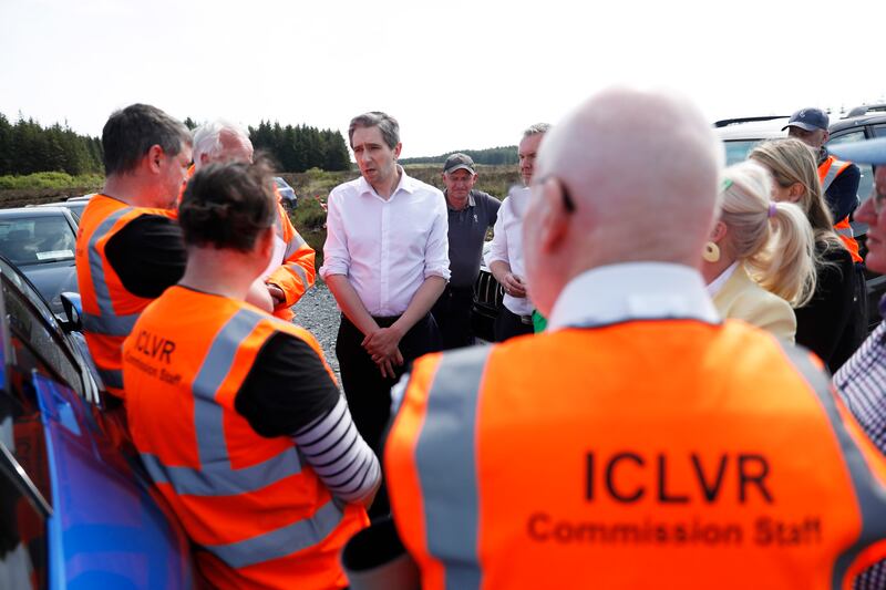  Simon Harris, talks with members of the Independent Commission for the Location of Victims' Remains (ICLVR), during a visit to the remote Bragan Bog in Co Monaghan last week, where a painstaking dig for missing teenager Columba McVeigh is ongoing. Photograph: Peter Morrison/PA Wire
