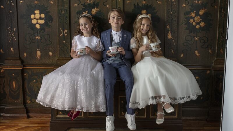 Hollie: white lace dress, €340, Laura D; red Dalmation shoes, €80, Kurt Geiger; sequin emblem headband, €46, Orelia. Sophia: ivory dress, €330, cream embellished headband, €45, Glitz+Pieces; white satin shoes, €45, Rainbow Club. Sam: blazer, €99, waistcoat, €36, shirt, €30, trousers, €46 all 1880 Club; white shoes, €55, Lacoste.