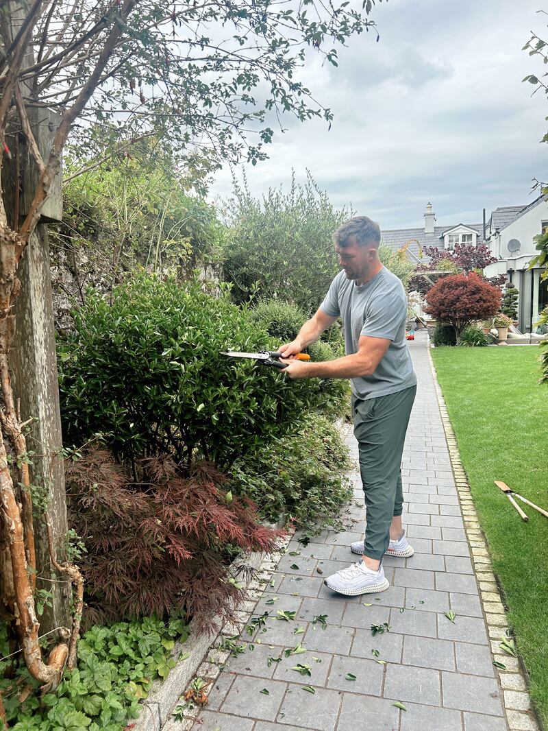 Peter O'Mahony pruning plants in his garden