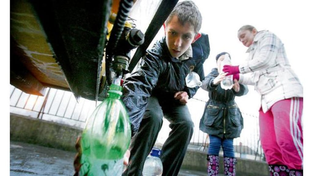 residents from Ventry park in Cabra, Dublin fill up bottles of water from a council tanker.