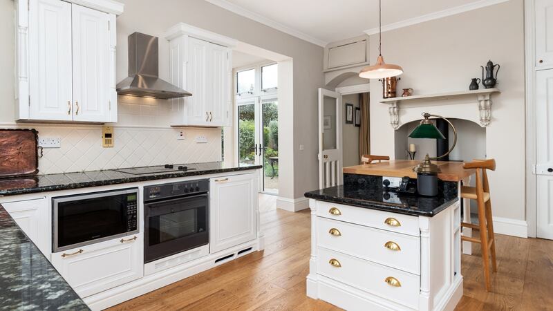 In the kitchen, hand-built units are all painted white.