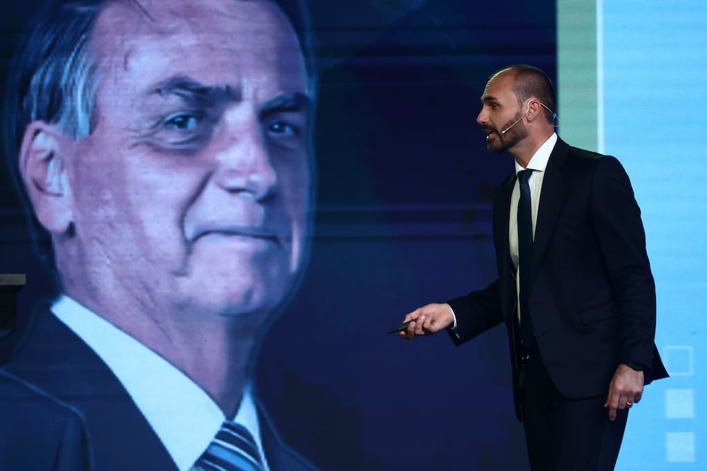 Eduardo Bolsonaro next to an image of his father, former Brazilian president Jair Bolsonaro, in 2024. Photograph: Tomas Cuesta/Getty Images