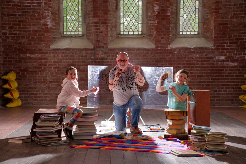 Author and illustrator Brian Fitzgerald and local school children Dara Sheridan (8) and Abigail Hanley (8) at the Red Chapel in Kells, one of the venues hosting this year’s Hinterland Festival events, at the launch of the 2026 Hinterland Festival of Literature & Arts programme.
 Photograph: Barry Cronin.