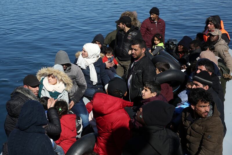 Asylum seekers are prevented from disembarking from a dinghy after they arrived at the small port of Thermi with the help of a life guard vessel on Lesvos island, Greece on Sunday. Photograph:  Orestis Panagiotou/EPA