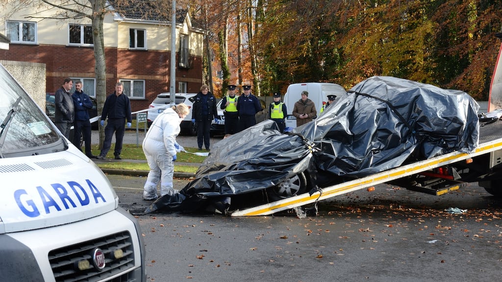 Garda and forensic experts at the scene where a man’s body was found in a burned-out car in Mount Andrew Rise, Lucan, Co Dublin, on Monday evening. Photograph: Dara Mac Dónaill