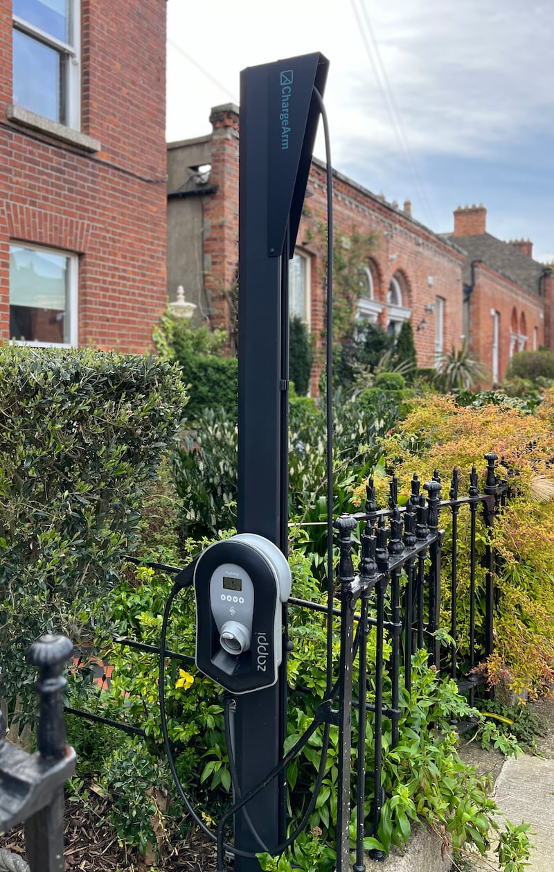 Extendable charging arms for electric vehicles in the front gardens of homes in a Dublin suburb.  Photograph: Bryan O’Brien
